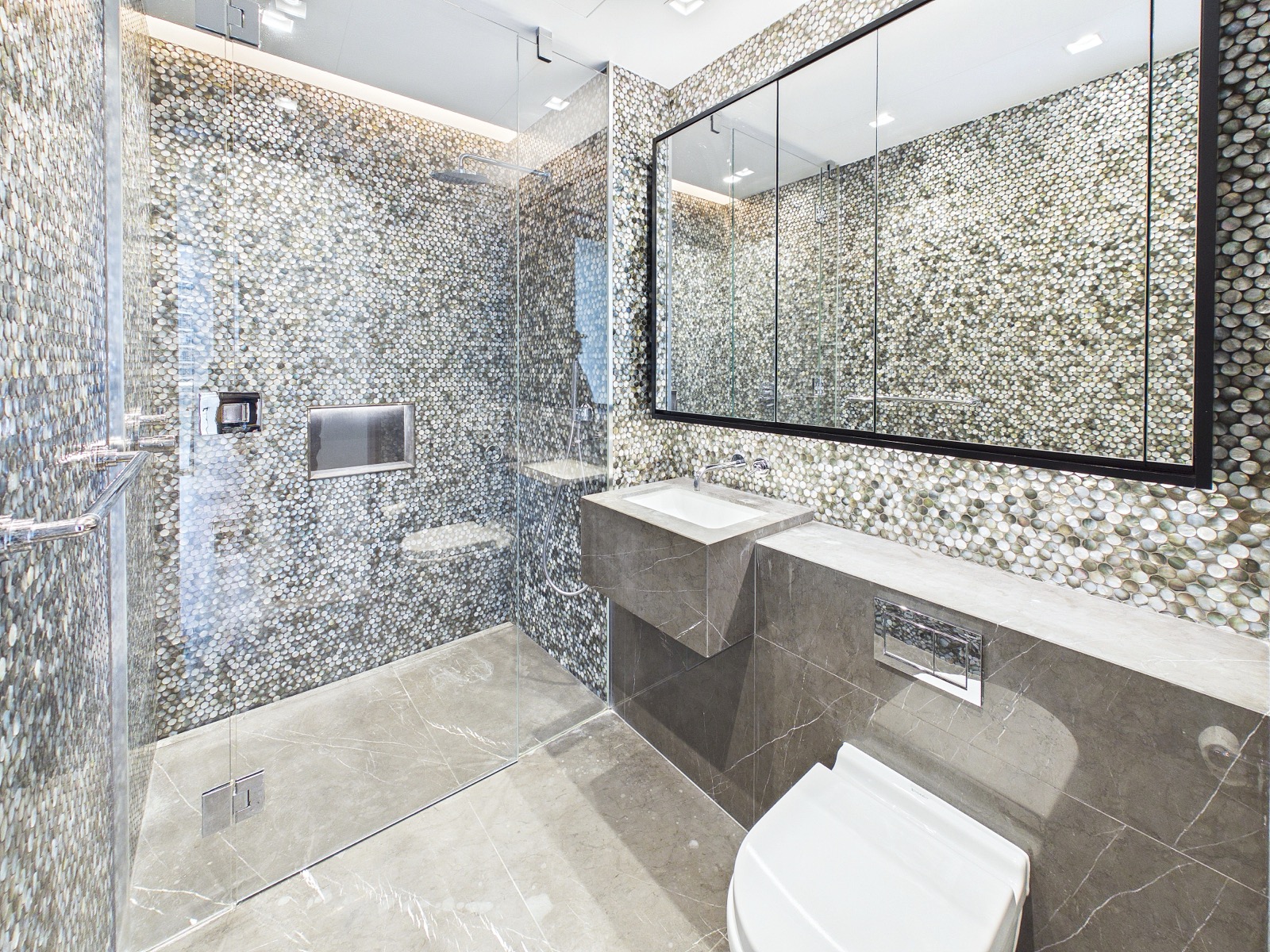 Shower room in stone mosaic — One Park Drive, Wood Wharf